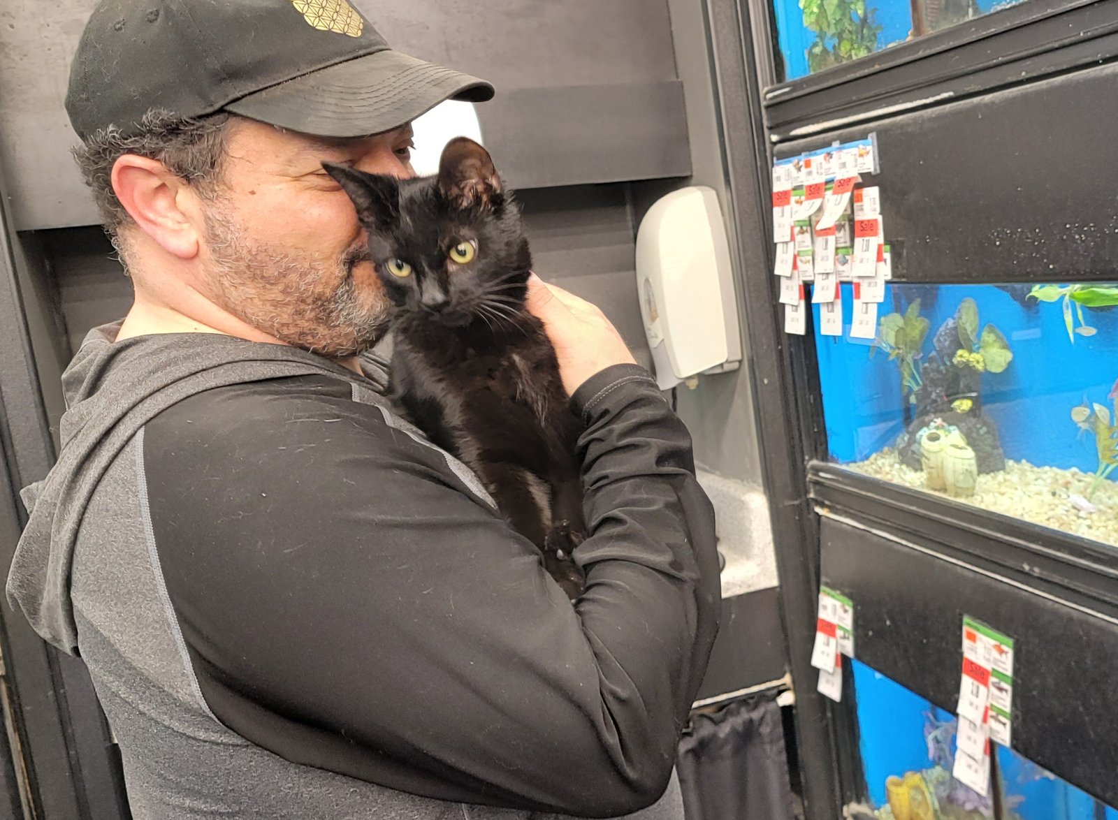 Dr. James kissing a black rescue kitten at the shelter