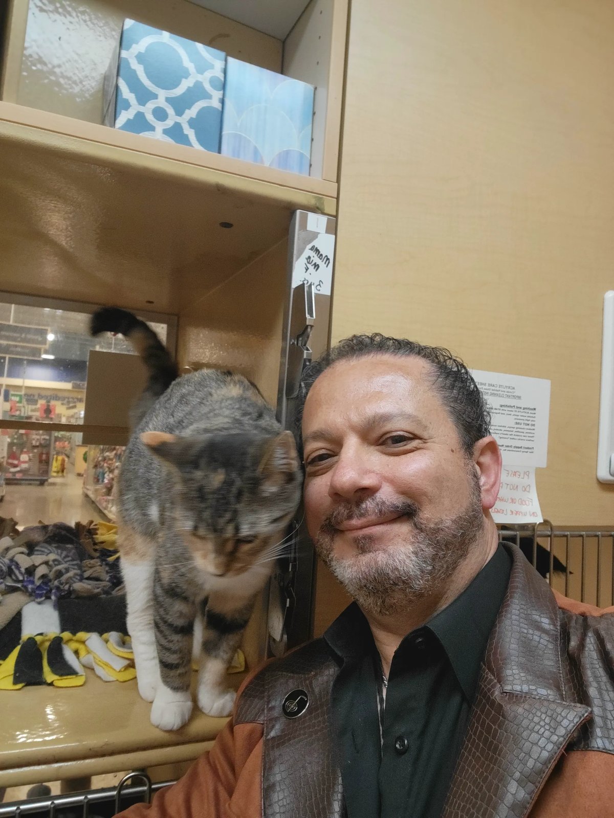 Dr. James with a calico tabby cat at the rescue shelter
