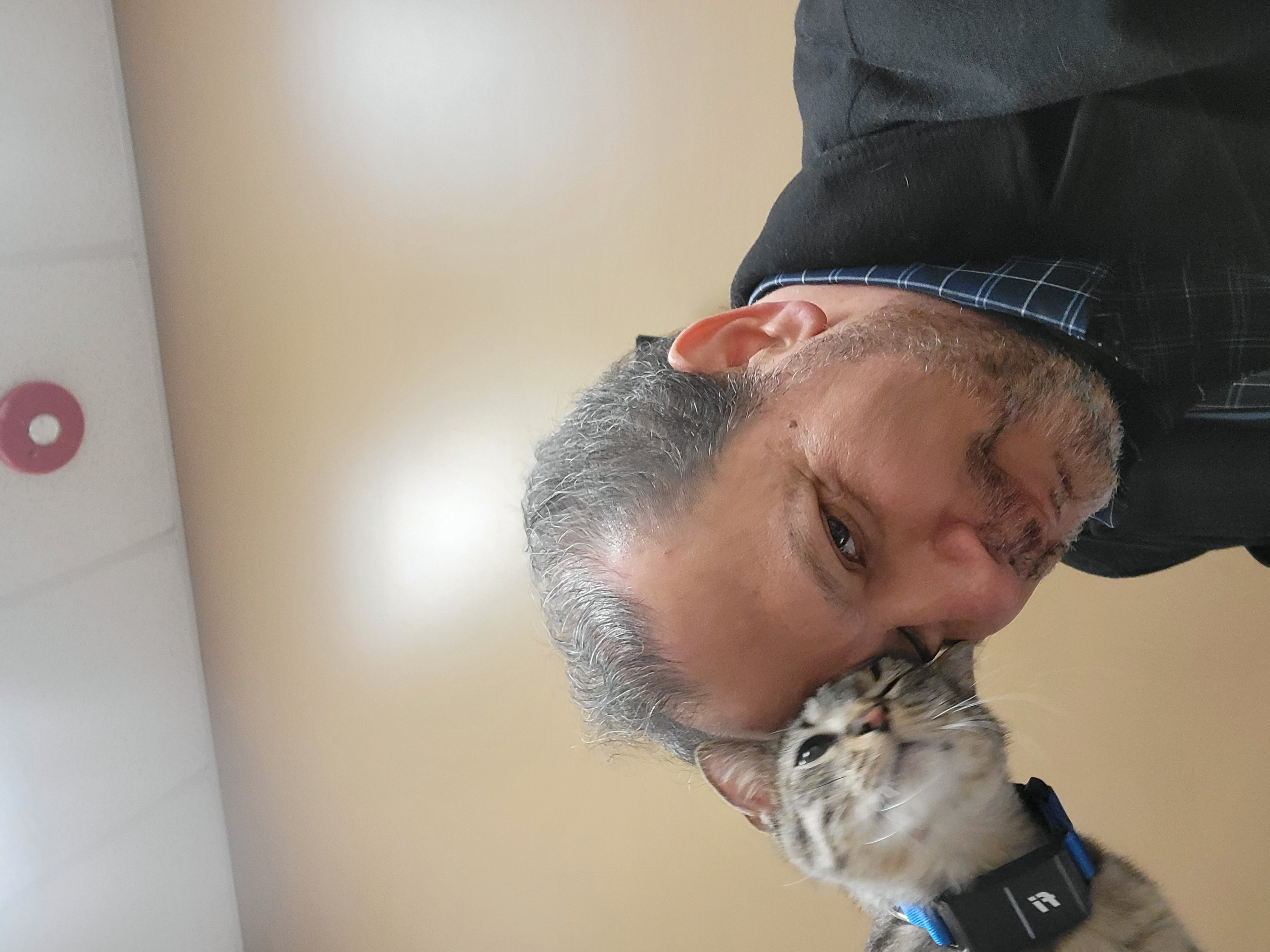 A cat nuzzling Dr. James on the forehead