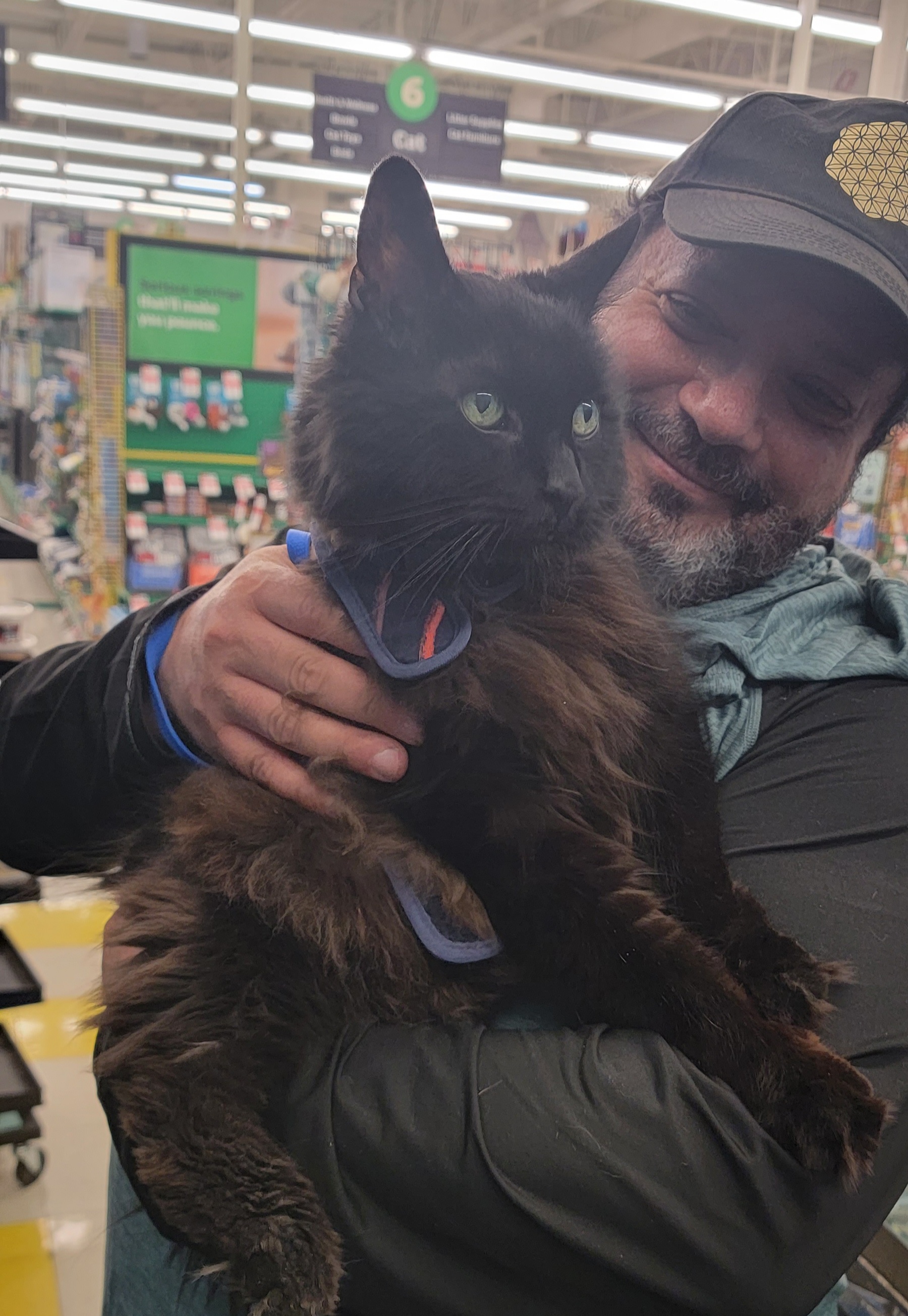 Dr. James holding a black fluffy cat
