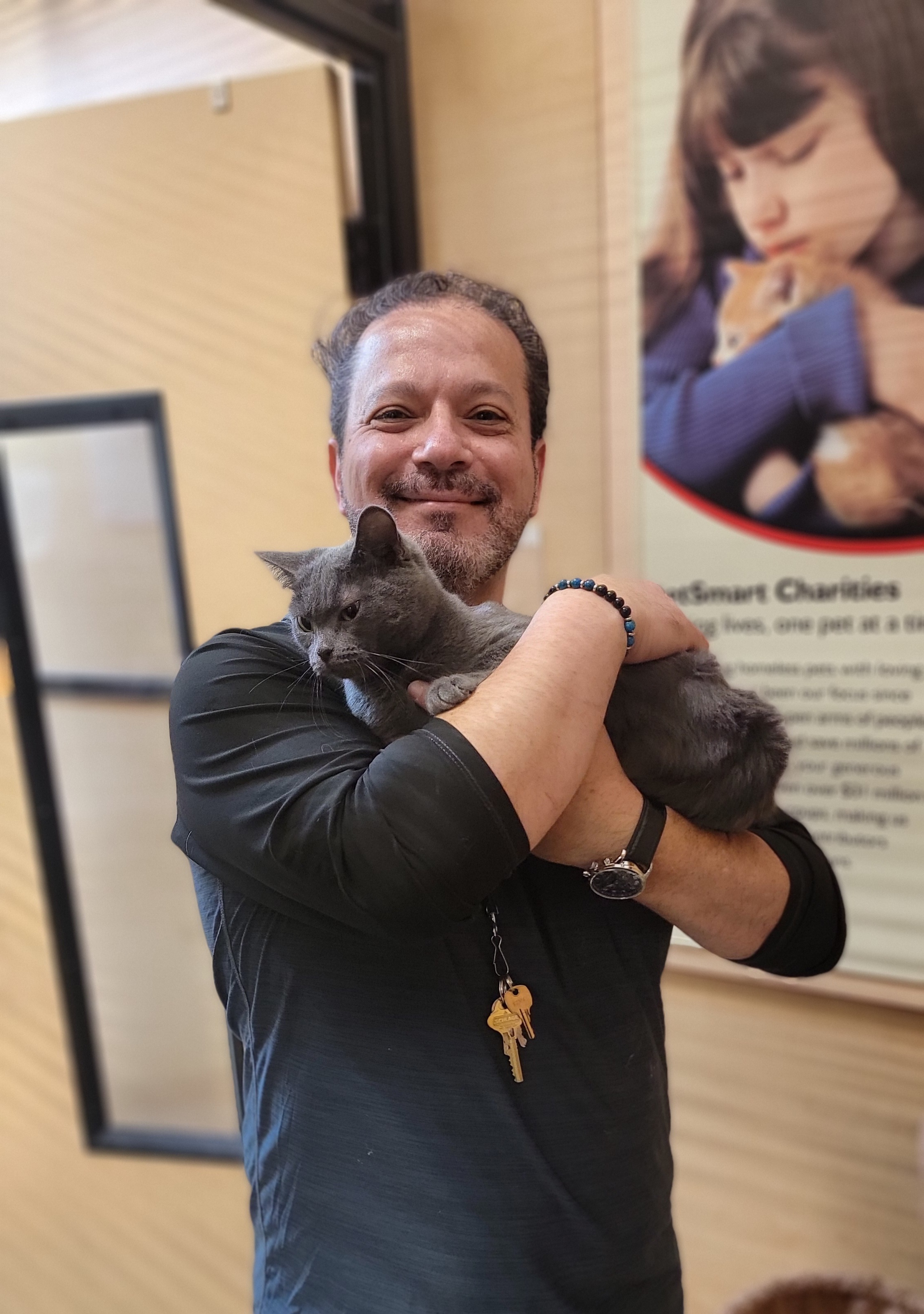 Dr. James holding a grey rescue cat