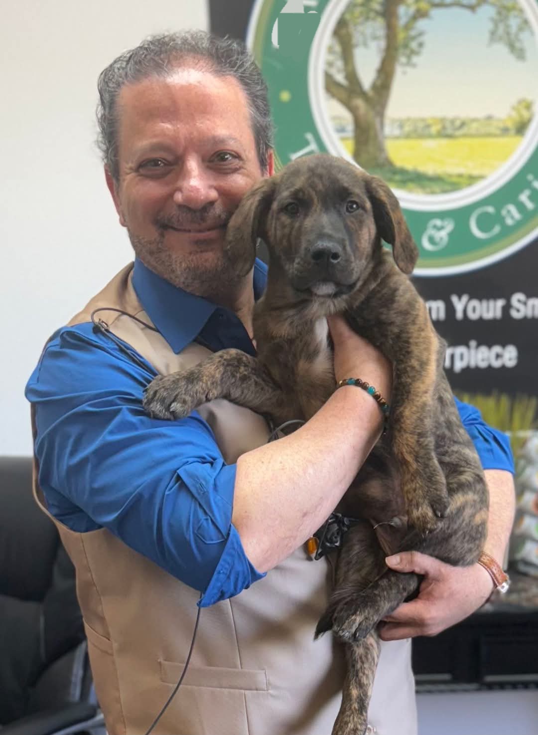 Dr. James holding a rescue puppy at Da Vinci Dental