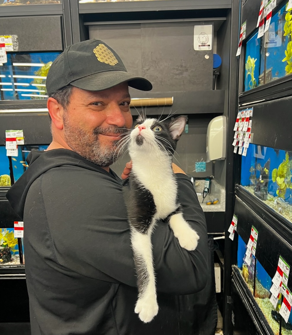 Dr. James holding a tuxedo cat