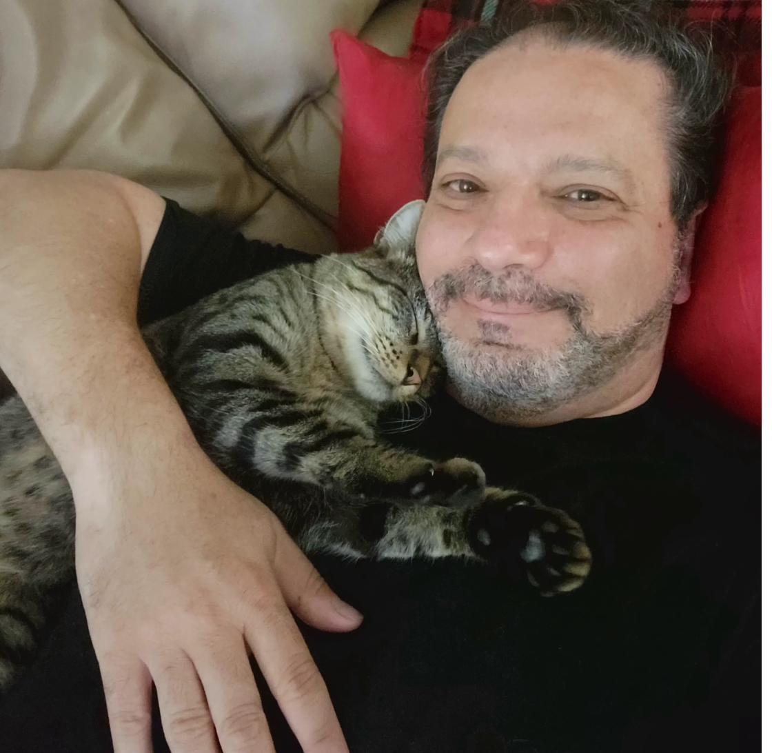 Dr. James with his cat Valentine sleeping on his chest